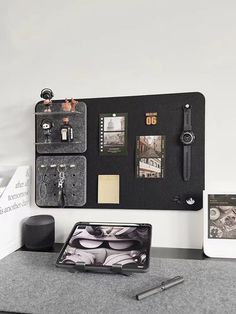 there is a black and white photo on the wall next to an ipad, pen and other items