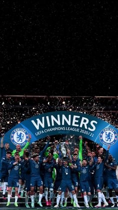 the chelsea team celebrate with the trophy