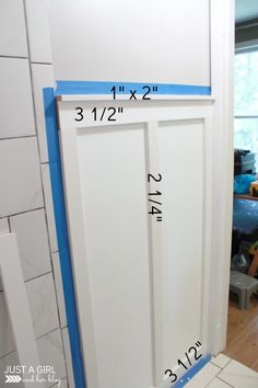 the measurements are displayed on the wall in front of the door to the bathroom area