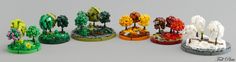 a group of small lego trees sitting next to each other on top of a table