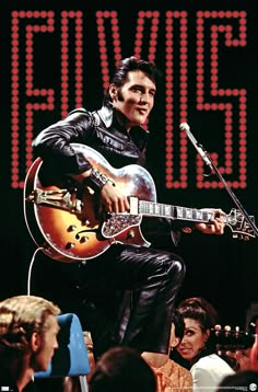 elvis presley playing guitar in front of an audience