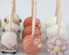 small cake pops with flowers and peace signs on them