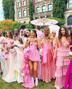 a group of women standing next to each other in dresses