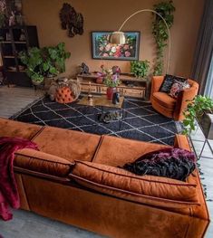 a living room filled with furniture and plants