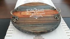 a round wooden box sitting on top of a white tablecloth covered placemats