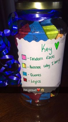 a jar that has some kind of candy in it with ribbon around the top and label reading key random fact reason why i love you