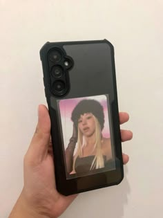 a person holding up a cell phone case with an image of a woman on it