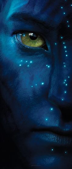 a man's face with glowing blue paint on his face and yellow eyeliners