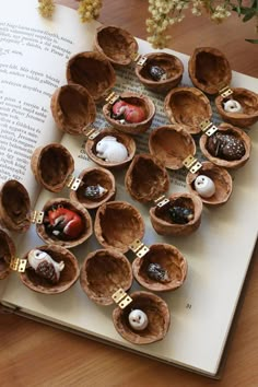 an open book sitting on top of a table filled with chocolates and strawberries