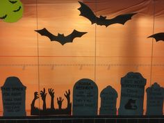 the silhouettes of bats and tombstones are on display in front of an orange sky