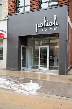 the storefront of a clothing store with snow on the ground in front of it