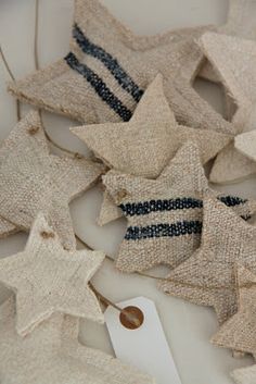 a pile of burlap stars with tags on them