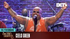 ceelo green performing at the bety awards with his arms up in the air