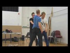 three young men are dancing in a dance studio