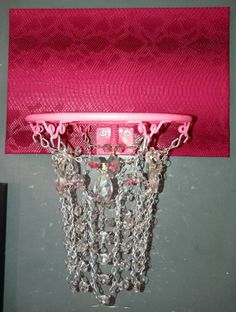 a pink basketball hoop with chains hanging from it