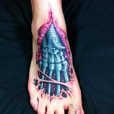 a foot with a tattoo on it that has a pink and blue design on it