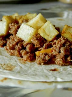 a tortilla filled with meat and potatoes