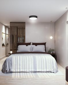 a bedroom with a bed, nightstands and lamps on either side of the bed