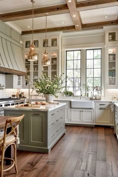 a large kitchen with wooden floors and white cabinets