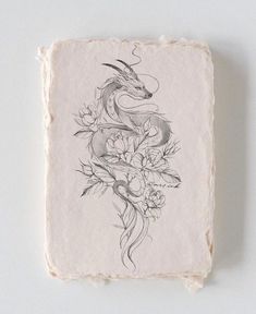 an ink drawing of a dragon on a piece of paper