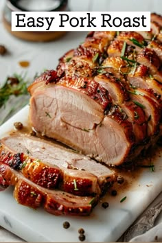 sliced pork roast on a cutting board with herbs and seasoning in the background text overlay says easy pork roast