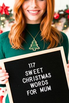 a woman holding up a sign that says 17 sweet christmas words for mum