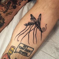 a man with a tattoo on his leg that has a dragonfly sitting on top of it