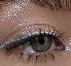 an eye with silver glitter on it