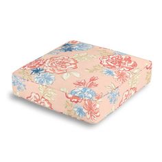 a pink and blue flowered square cushion