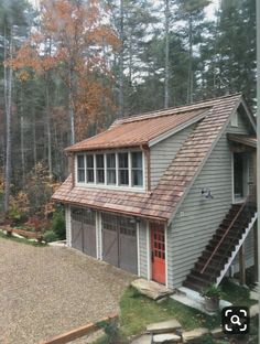 a house with a red door and stairs leading up to it