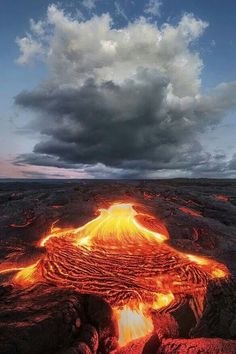 the lava in the ground is glowing red and yellow as it rises into the sky