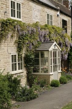 a house with flowers growing on the side of it