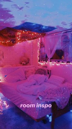 a bedroom with pink lights on the ceiling, and a bed in the middle of it