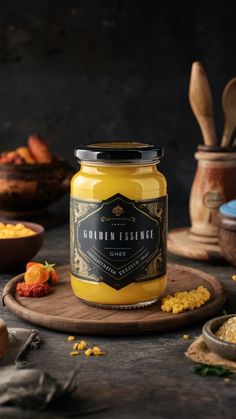 a jar of yellow sauce sitting on top of a wooden cutting board