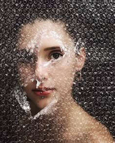 a woman's face is covered in water droplets