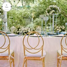 the tables are set with white linens and gold chairs for an elegant wedding reception