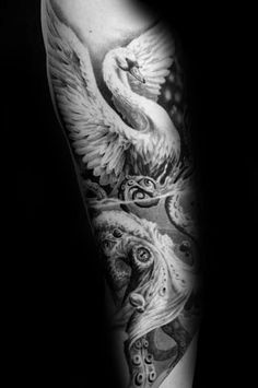 a black and white photo of a man's arm with an artistic tattoo design on it