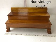 a wooden box sitting on top of a ruler