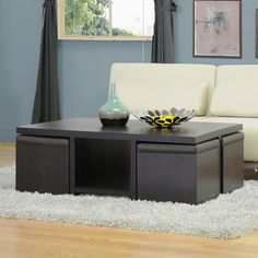 a living room with a white couch and coffee table in front of a blue wall