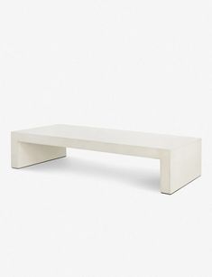 a white bench sitting on top of a white floor