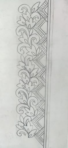 a drawing of a decorative design on a piece of paper, with lines and swirls