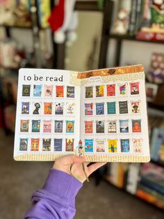 a person holding up a book with many different books on the front and back pages