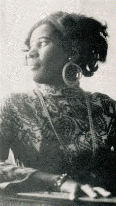 an old black and white photo of a woman with large hoop earrings on her head