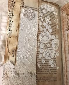 an open book with paper and lace on it