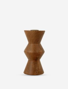 a wooden candle holder with an unusual shape on the top and bottom, made out of wood