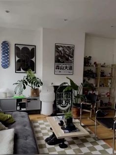 a living room filled with furniture and lots of plants