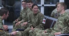 some soldiers are sitting together and laughing