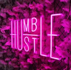 a pink neon sign that says humb hustle