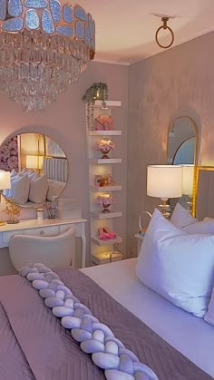 a bedroom with a chandelier hanging from the ceiling next to a large bed