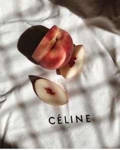 an apple sliced in half sitting on top of a white shirt